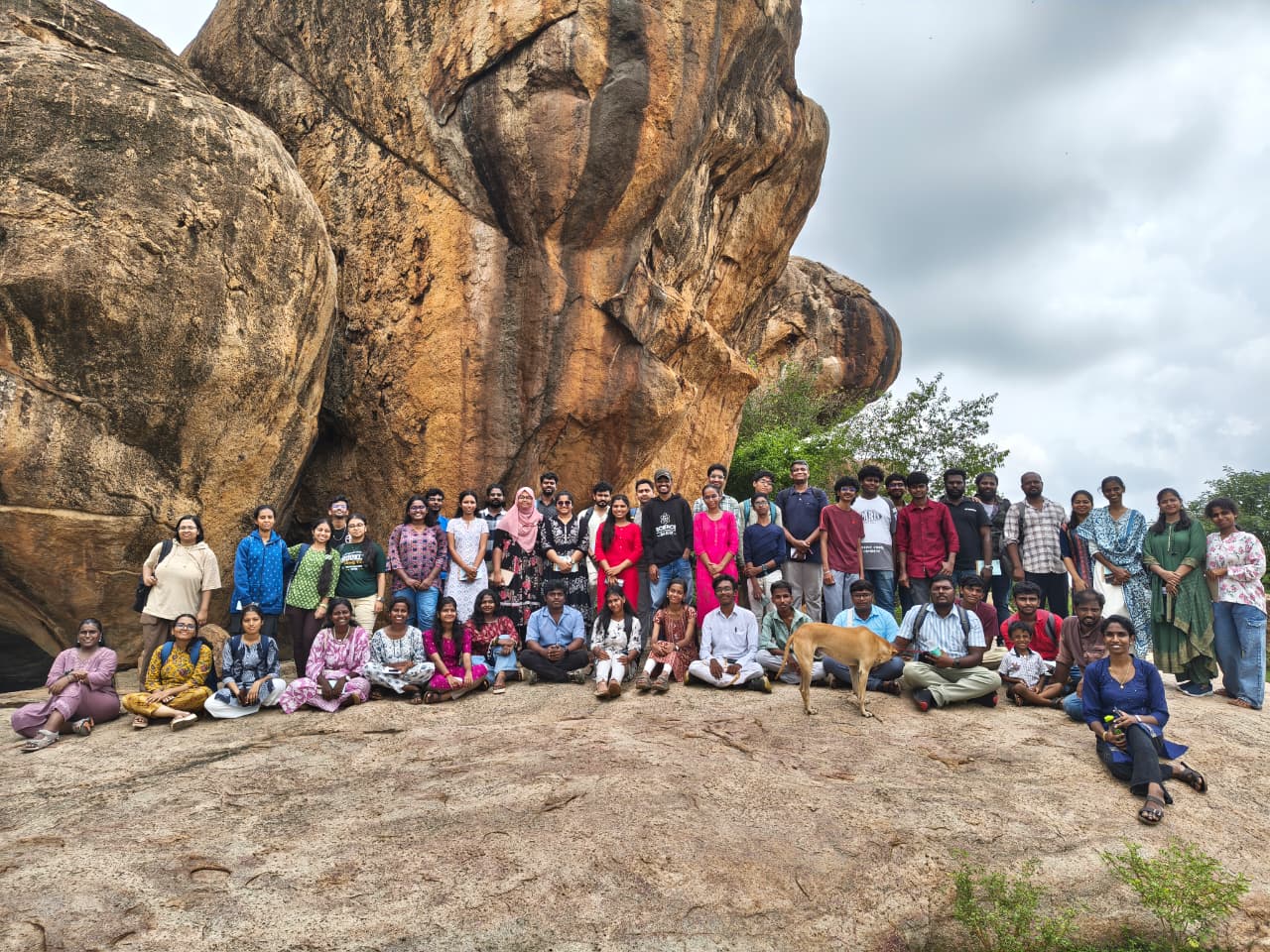 Participants gathered beside a rock formation during the heritage walk